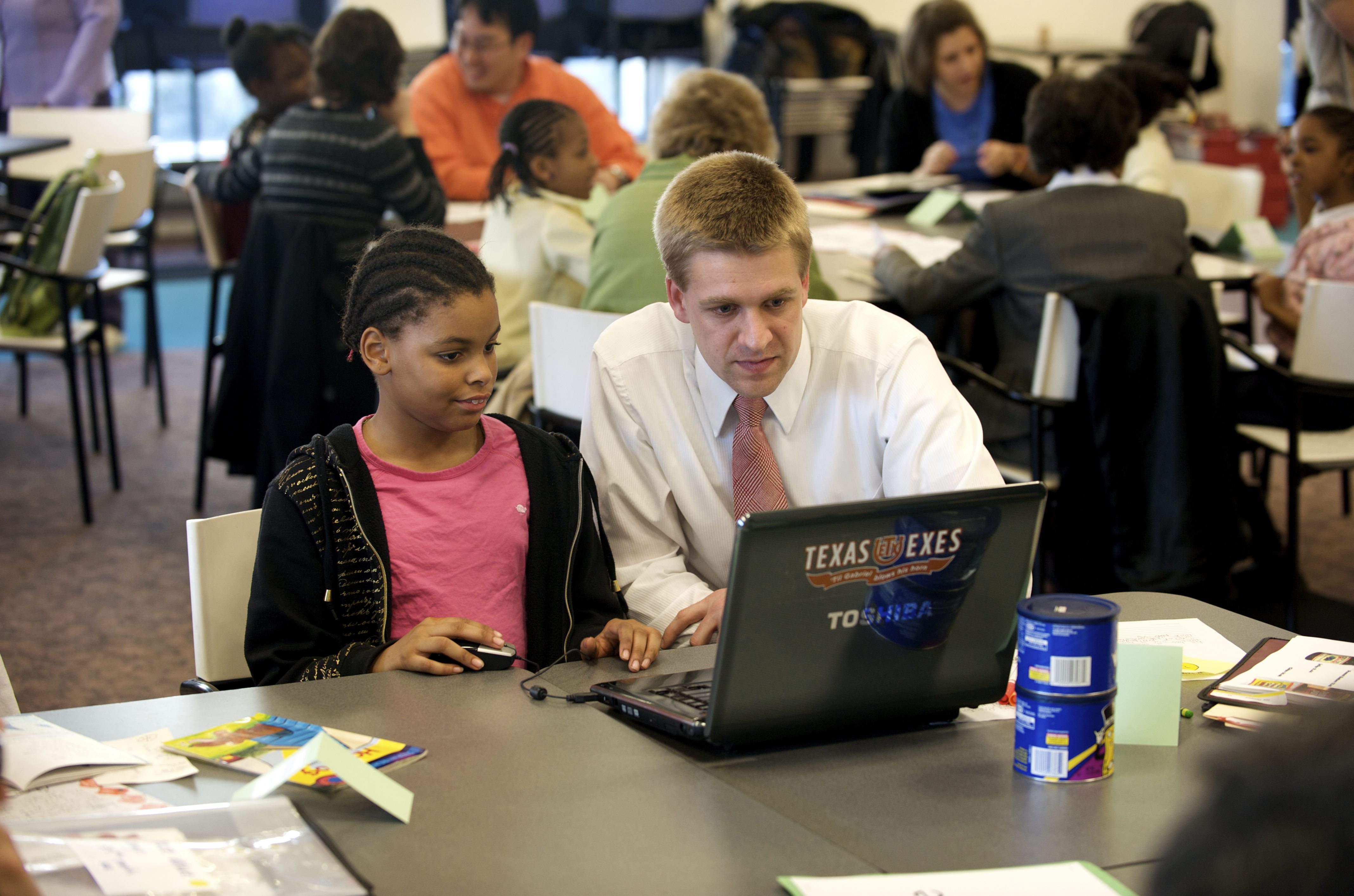 Young man working with a girl on the computer.